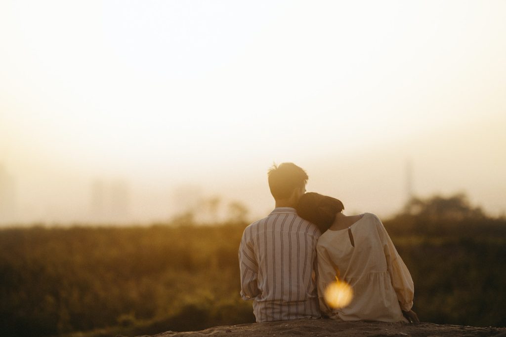 Man and Woman Near Grass Field