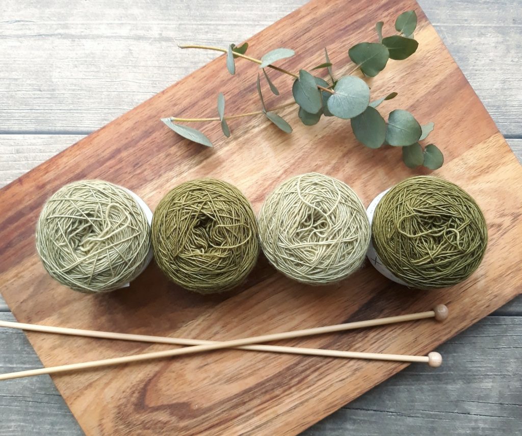 Four Green Yarns on Chopping Board