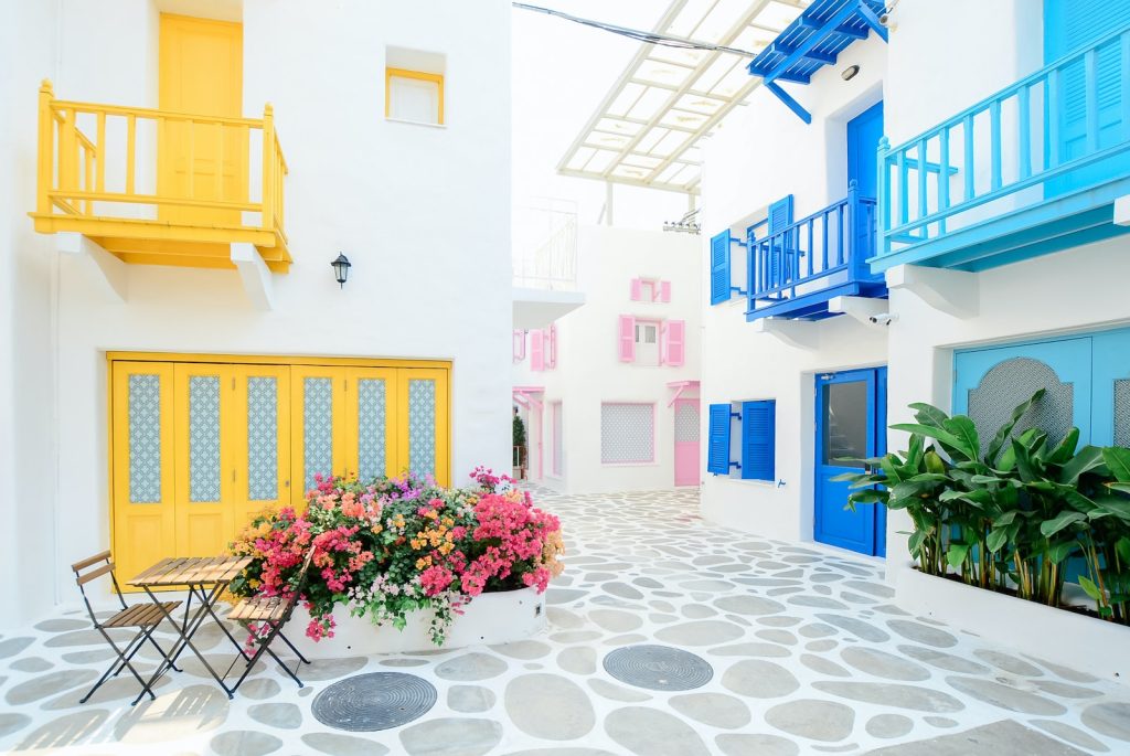 Architectural Photography of Three Pink, Blue, and Yellow Buildings