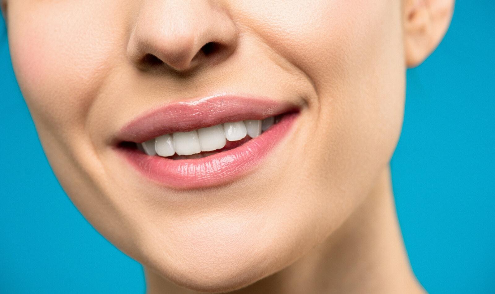 Close-up Photo of Woman With Pink Lipstick Smiling