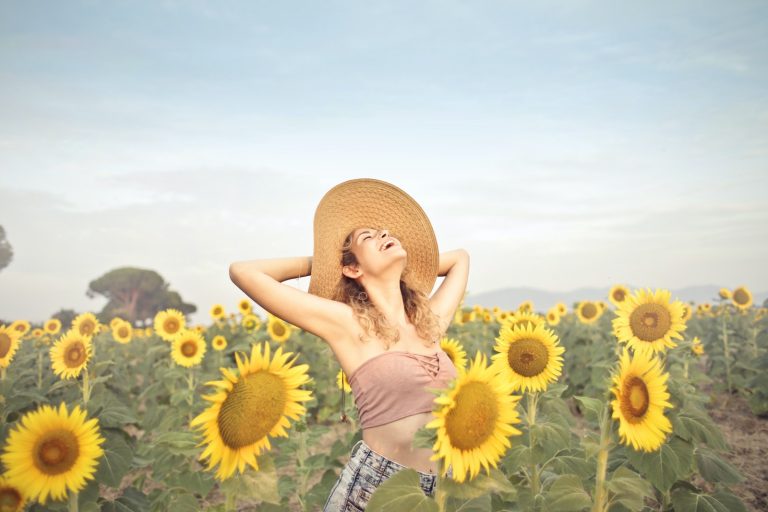 Woman Standing on Sunflower Field