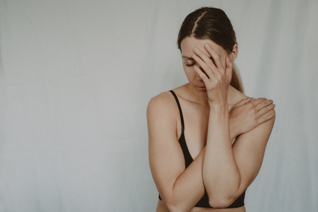 Young sad woman with closed eyes