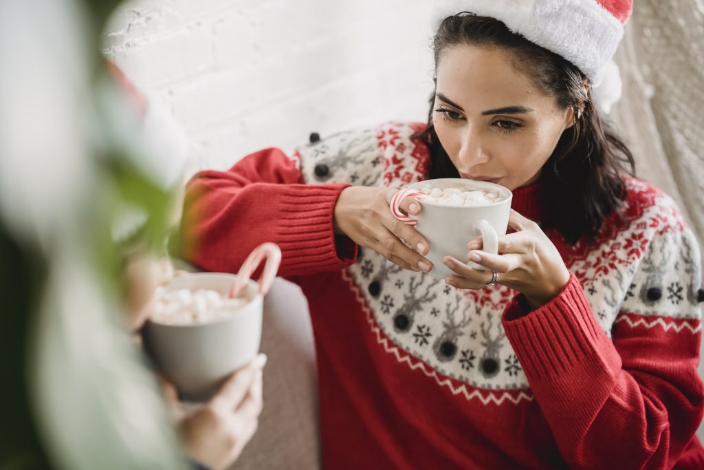 A Woman in Red Sweater Holding White Ceramic Cup