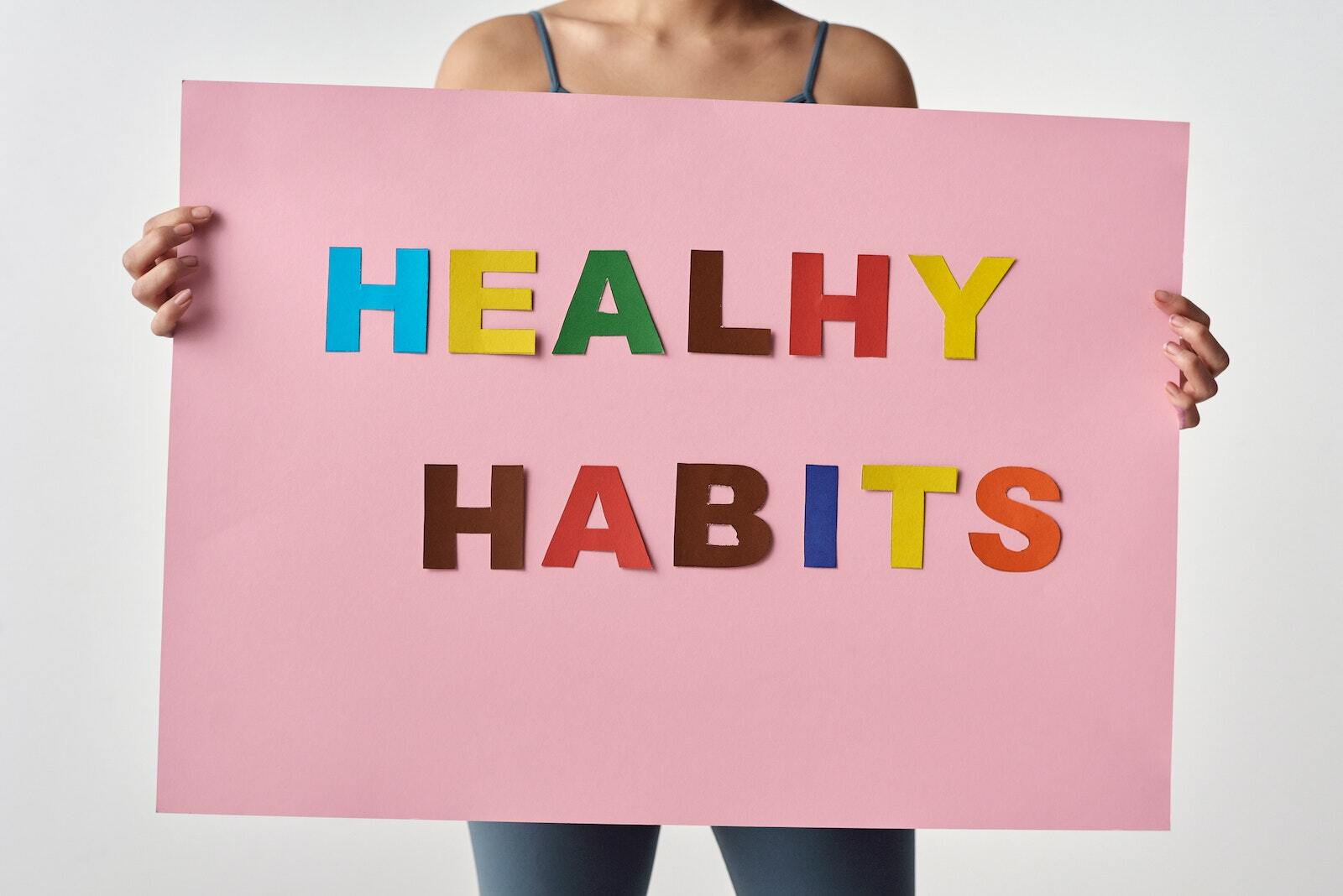 Person Holding a Pink Poster with Message