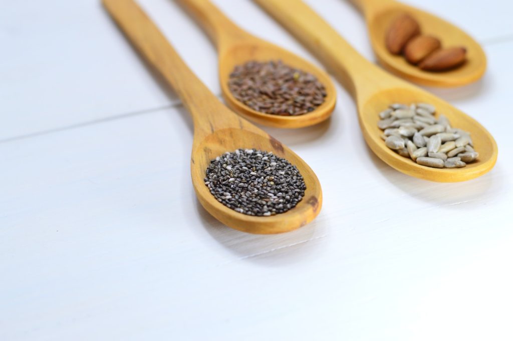 Closeup Photo of Four Brown Wooden Spatulas With Seds