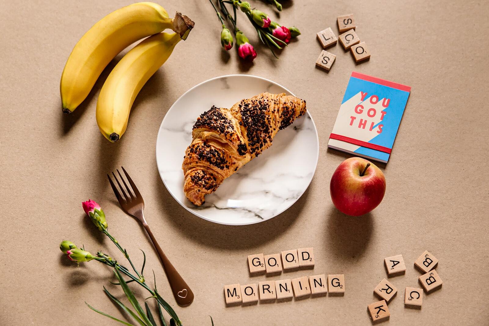 banana fruit and bread on white ceramic plate