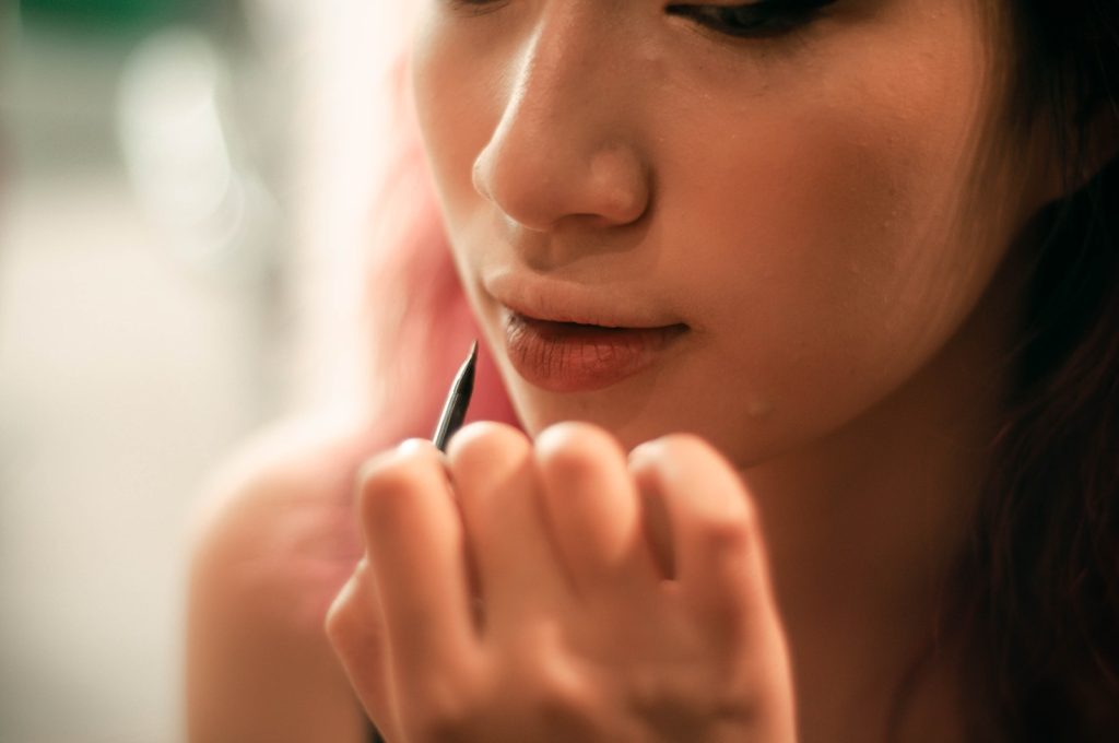 Close-Up Shot of Person Holding a Lip Liner