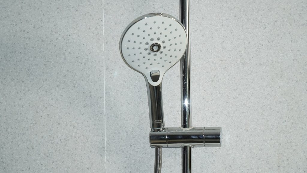 stainless steel shower head on white ceramic tiles