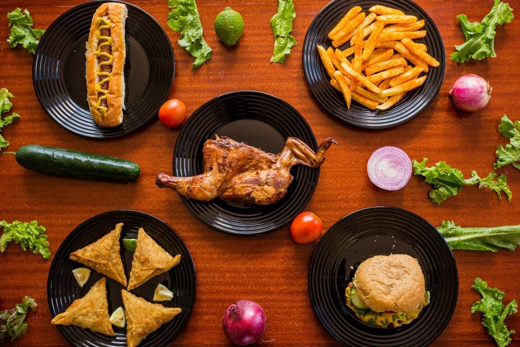 Variety of Foods on Black Ceramic Plates