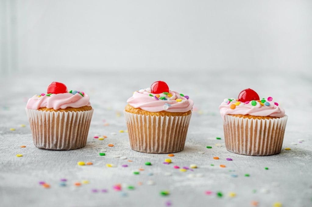 cupcakes with red and white icing on top