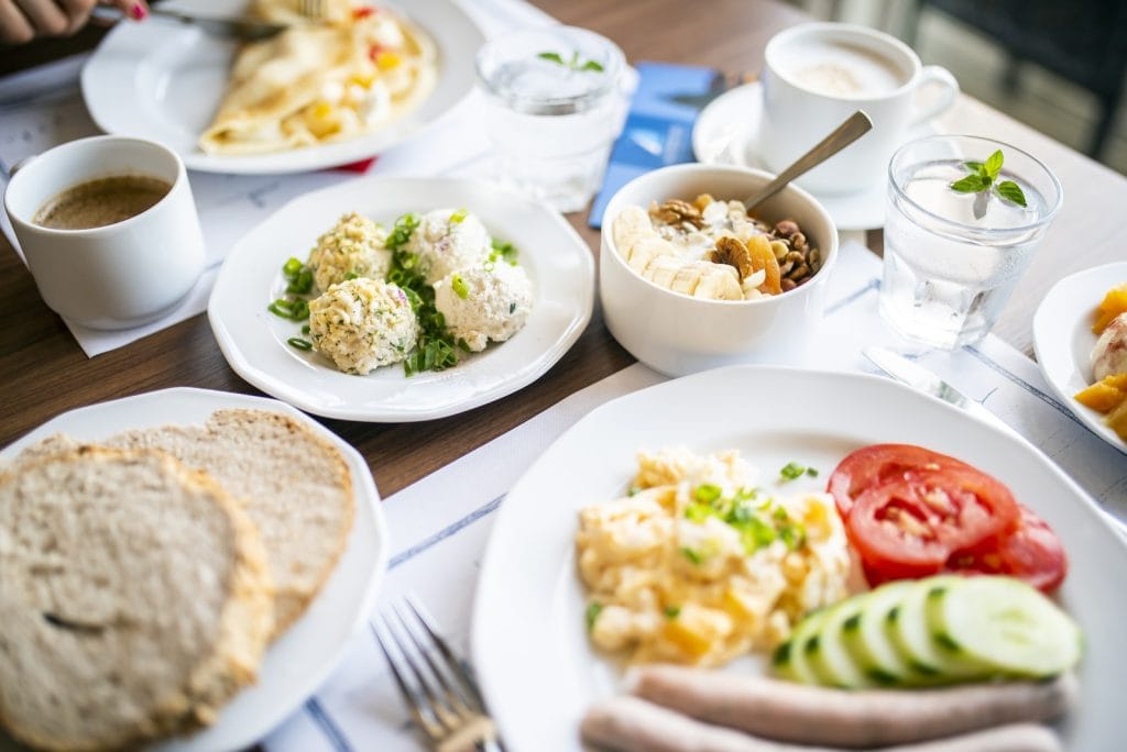 Delicious breakfast of steamed cutlets and omelet in restaurant