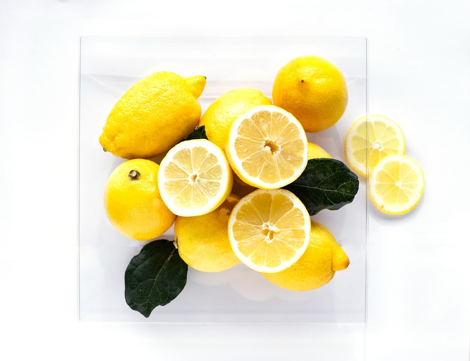 yellow lemon fruits on white surface