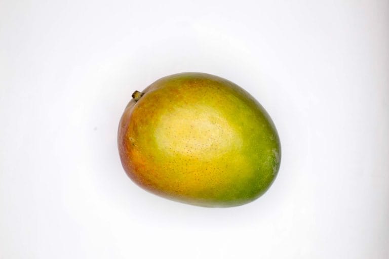 green round fruit on white surface