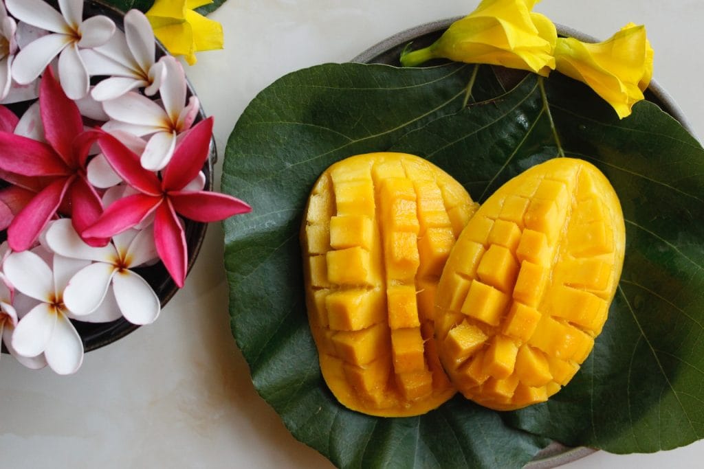 sliced mango on white ceramic plate