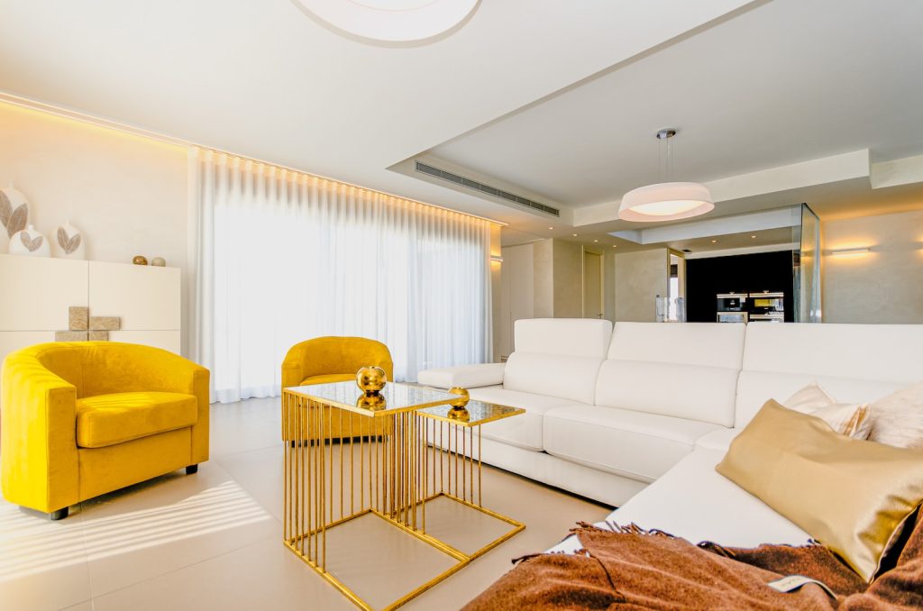 yellow sofa beside white sofa