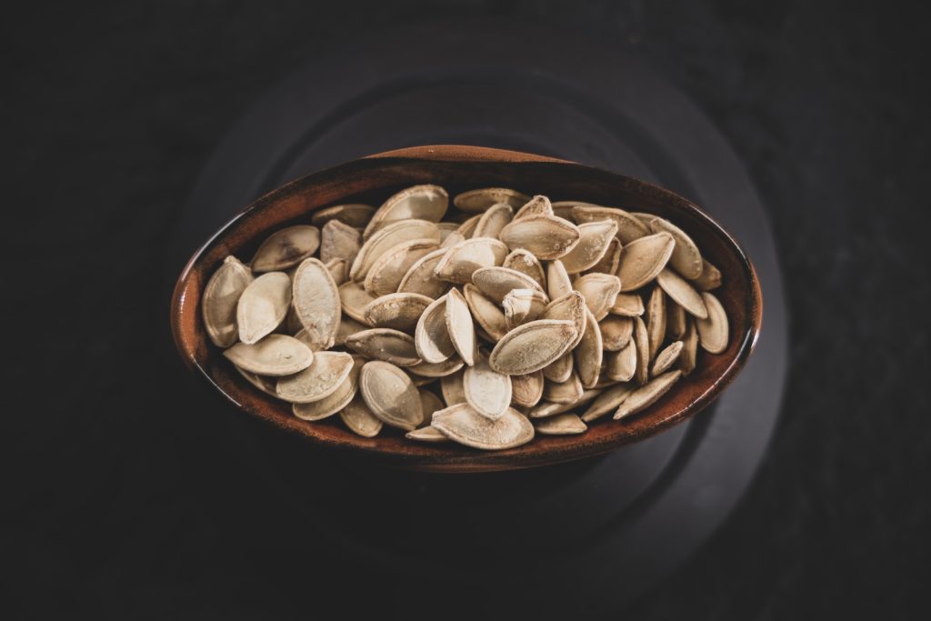 brown and white nuts on brown ceramic bowl