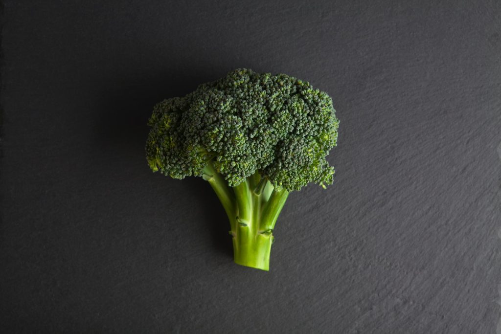 green broccoli on blue textile