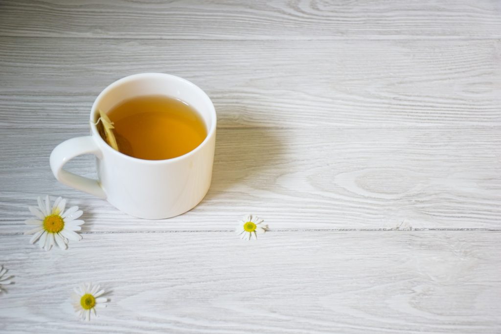 a cup of tea sitting on top of a white table