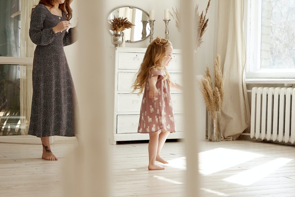 Woman Walking Behind Toddler