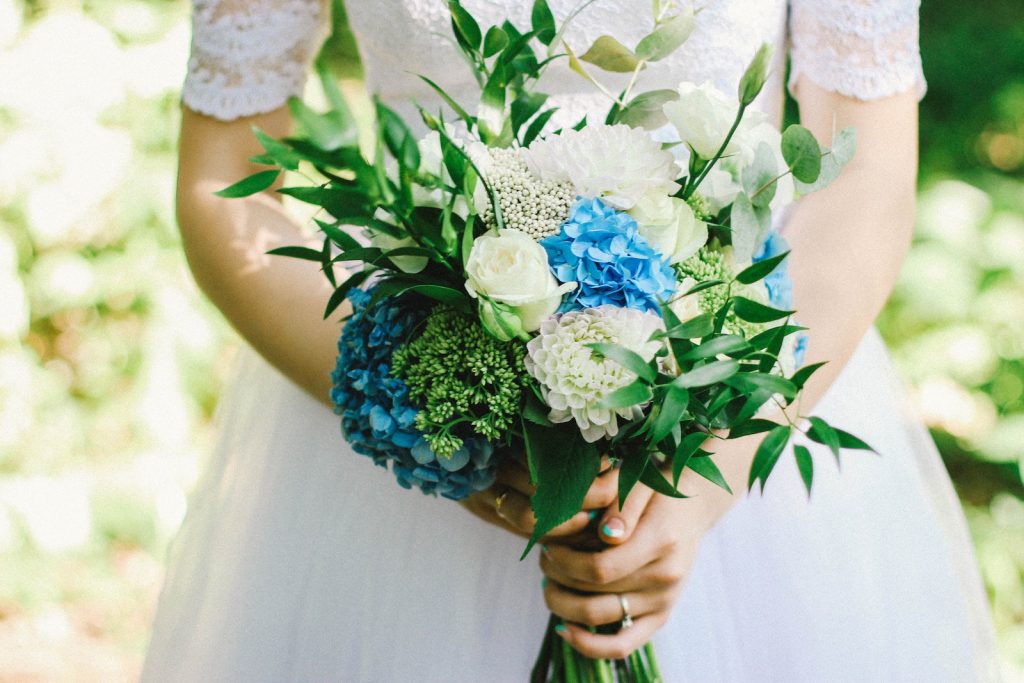 Person Holding White Flowers