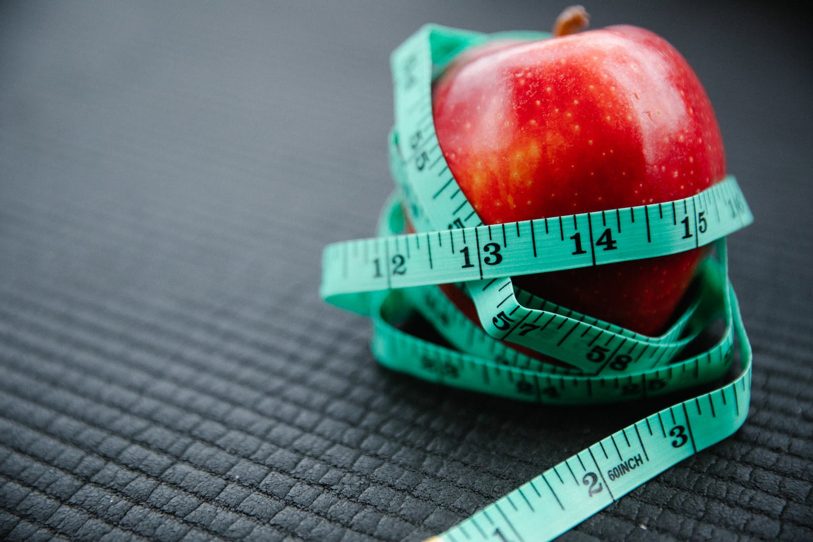 Measuring Tape Wrapped Around Red Apple