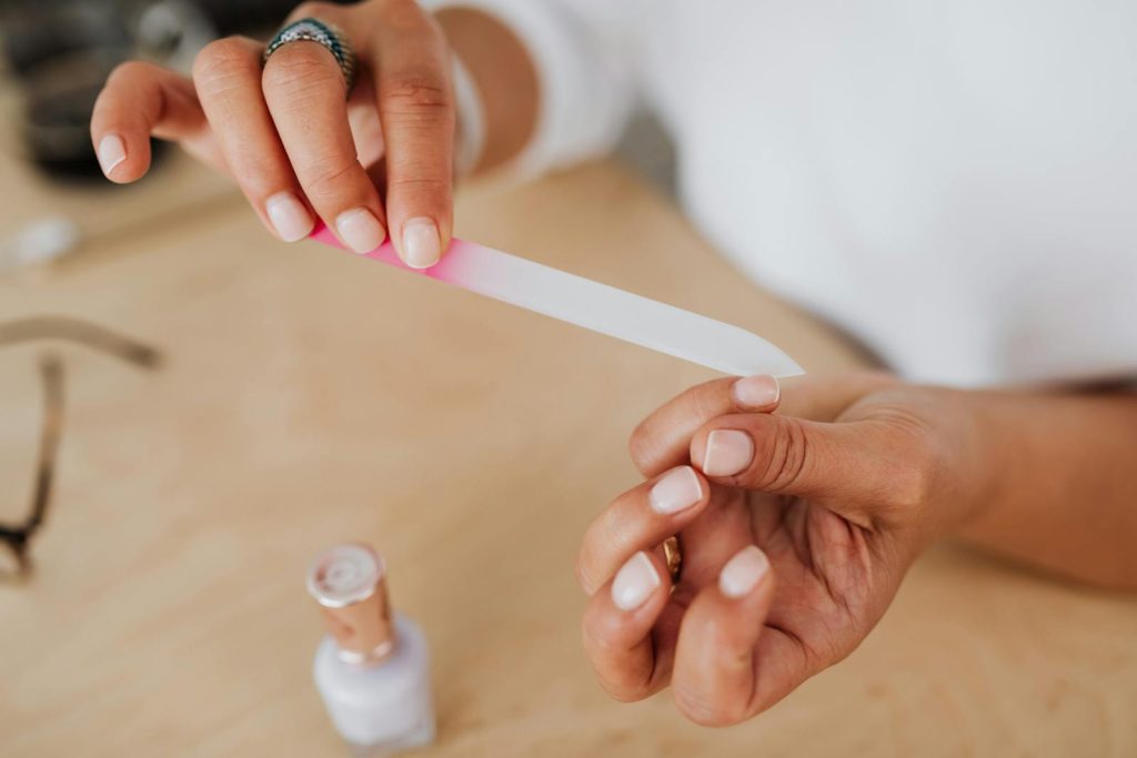 Person Holding White Nail File