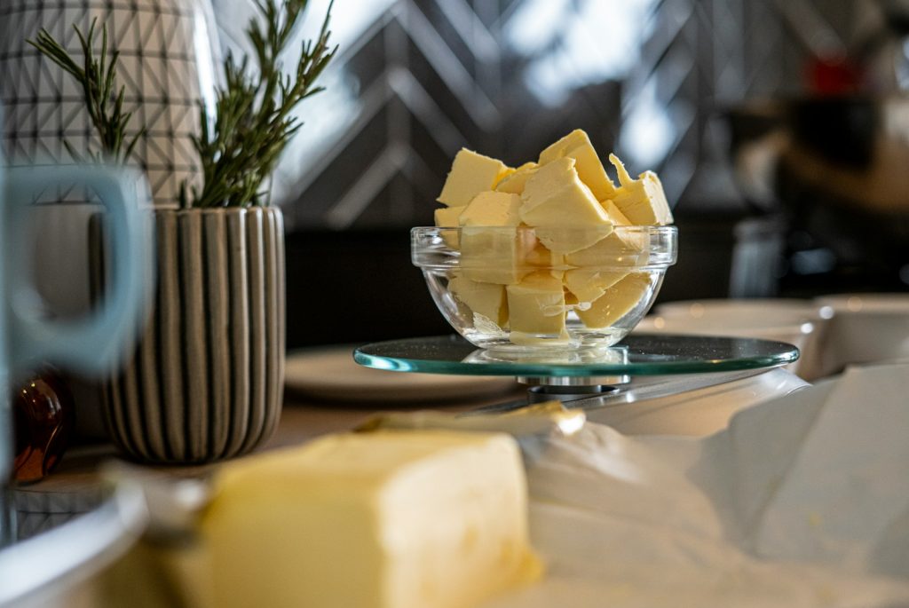 yellow cheese on green and white ceramic plate