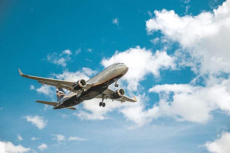 white airplane under blue sky during daytime