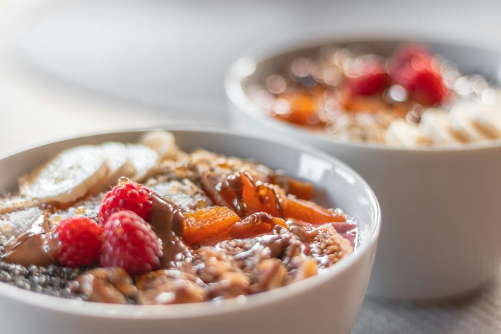 a bowl of oatmeal with fruit on top