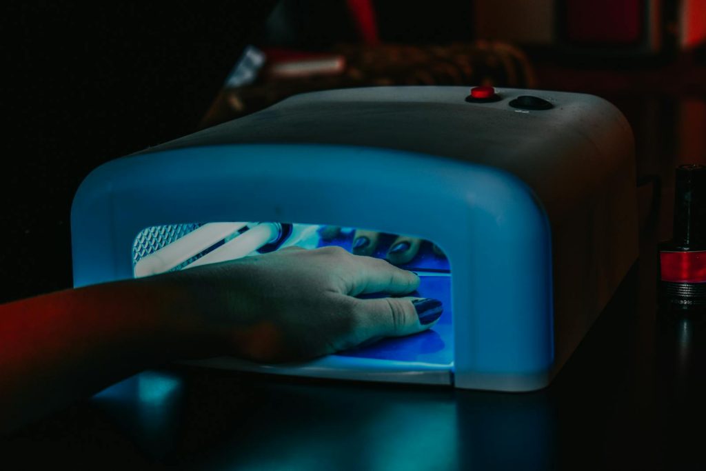 A Person's Hand Inside the UV Lamp