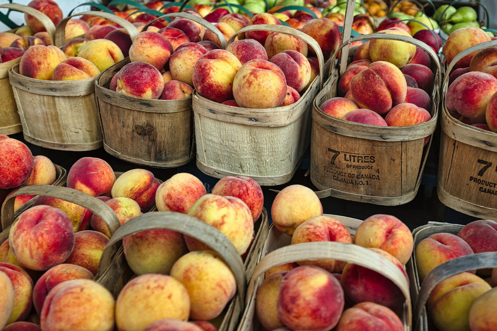 red-and-yellow apple fruit on baskets