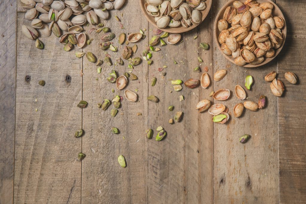 a wooden table topped with bowls filled with nuts